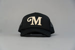 Load image into Gallery viewer, "M" Millionaire Essentials Black Trucker Hat